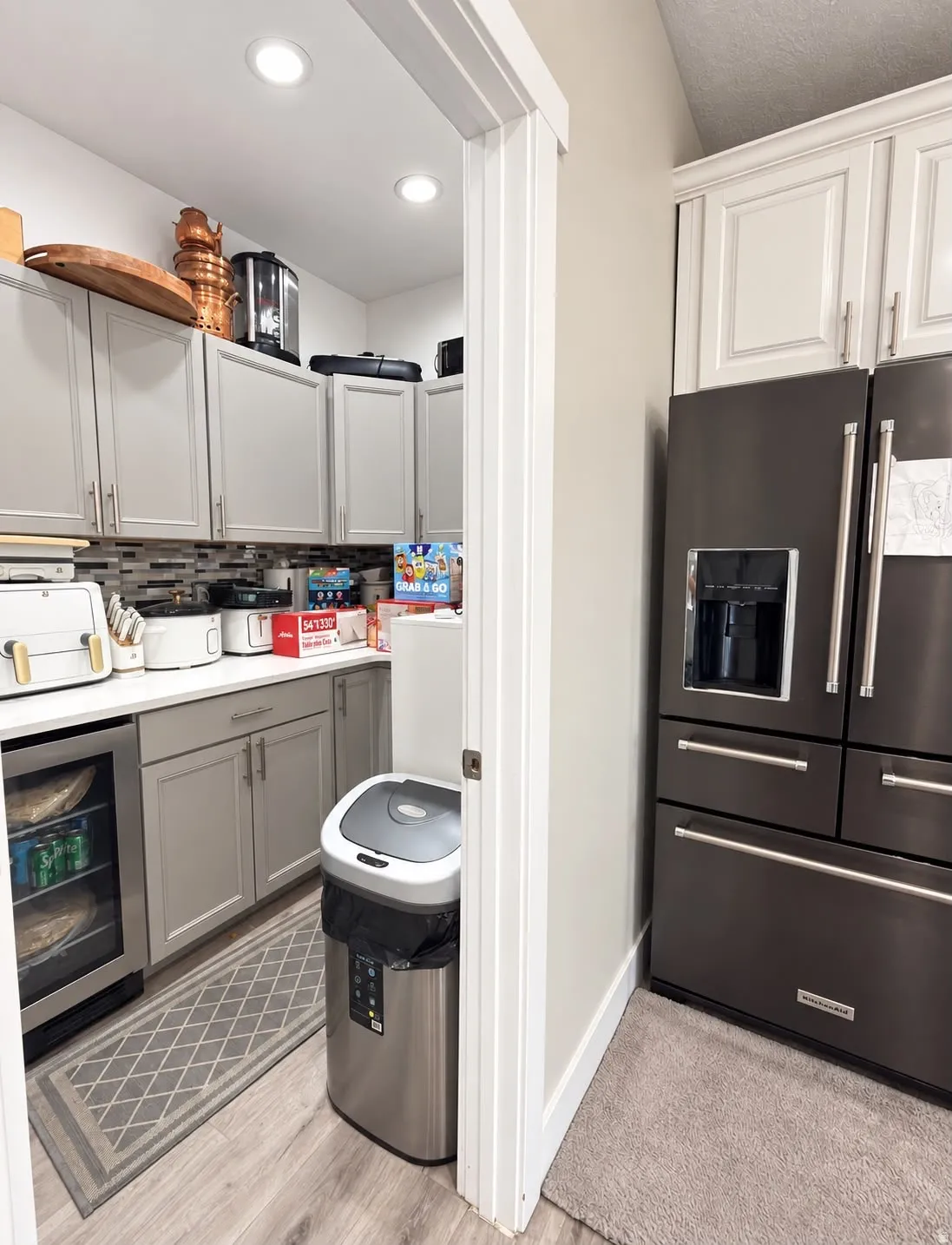 Kitchen pantry with recessed lighting, wood-finish flooring, and built-in beverage refrigerator