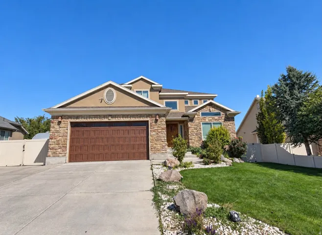 Stone and stucco exterior with a multi-level roofline