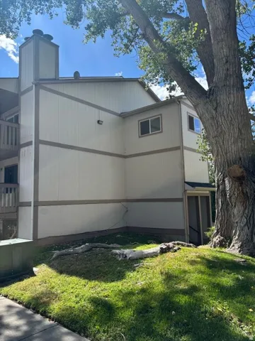 Multi-story building exterior with vertical siding and horizontal trim accents