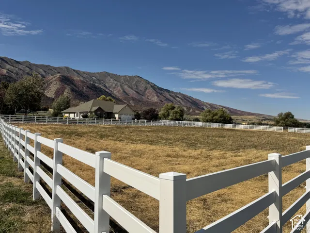 White perimeter fencing enclosing a spacious field