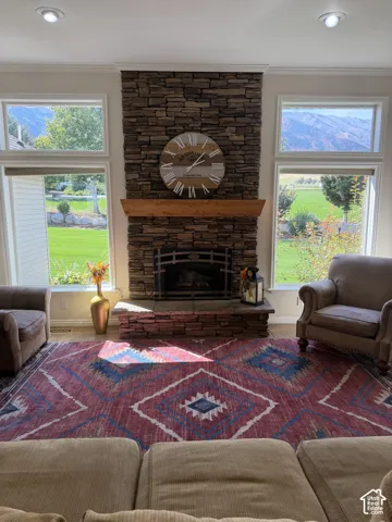 Stone-clad fireplace with a wood mantle