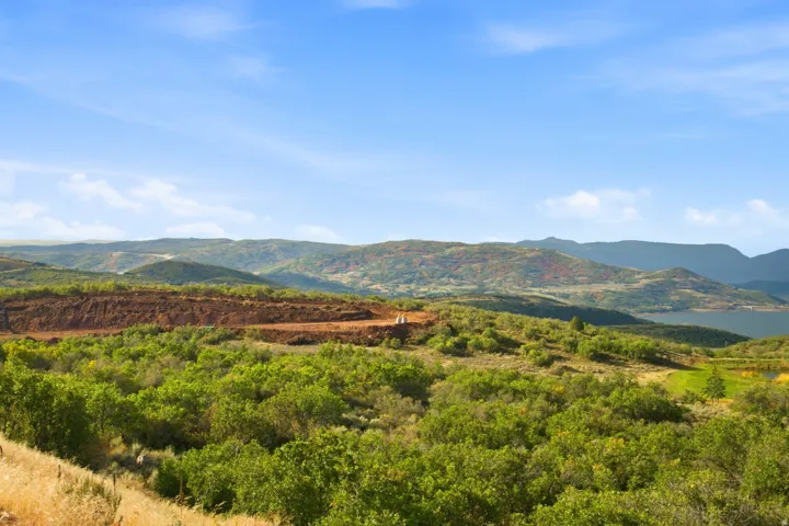 Expansive natural landscape featuring rolling hills and distant mountains