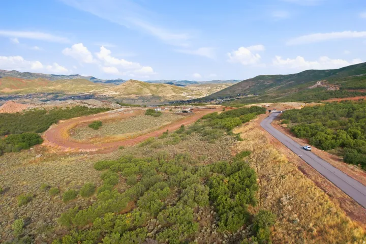 Winding paved road, natural landscape, and distant hills