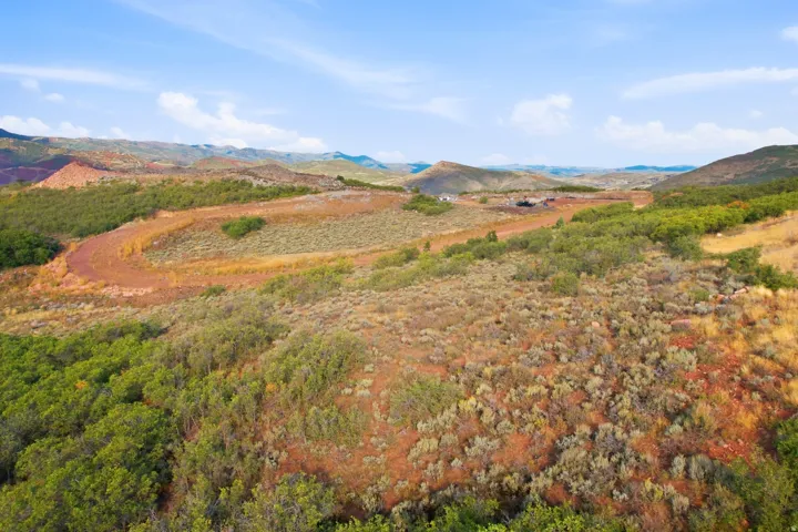 Expansive land parcel featuring natural terrain and distant mountains
