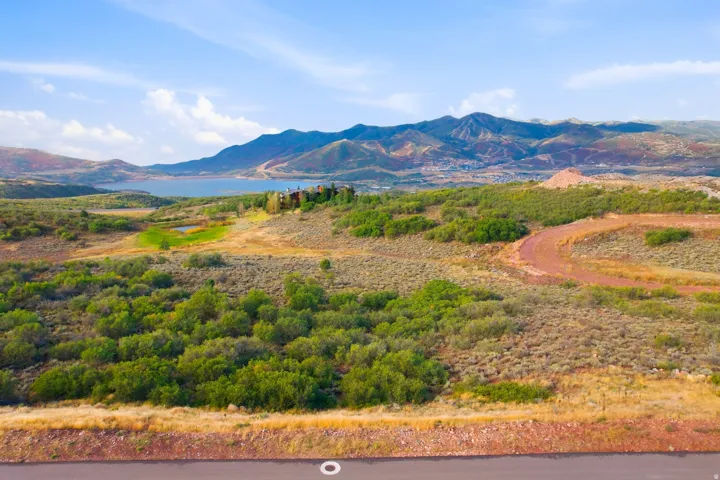 Expansive undeveloped land featuring natural terrain and distant mountainous scenery