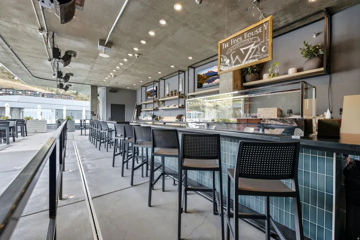 Concrete ceiling with recessed lighting and exposed conduit