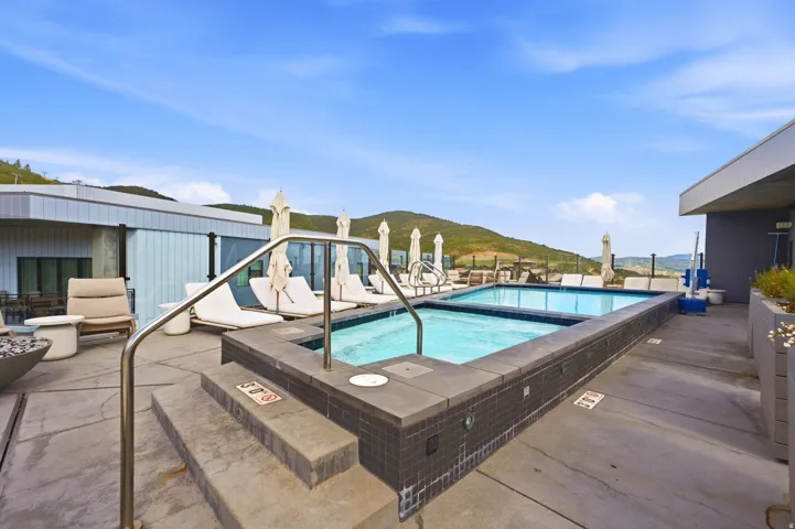 Rooftop pool and spa with mountain backdrop