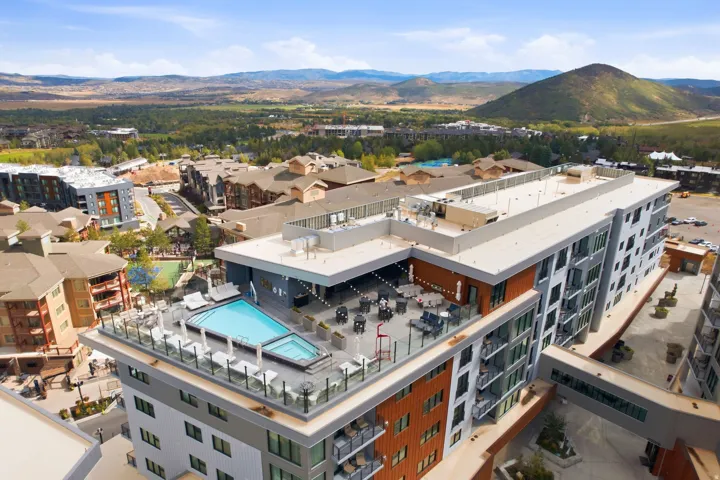 Rooftop amenity space featuring a swimming pool, integrated spa, and an outdoor lounge area