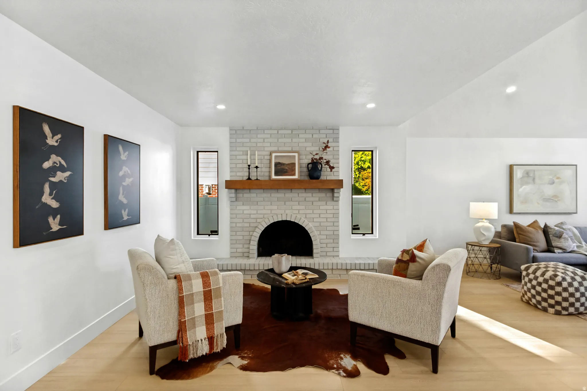Painted brick fireplace with an arched firebox and wood mantel