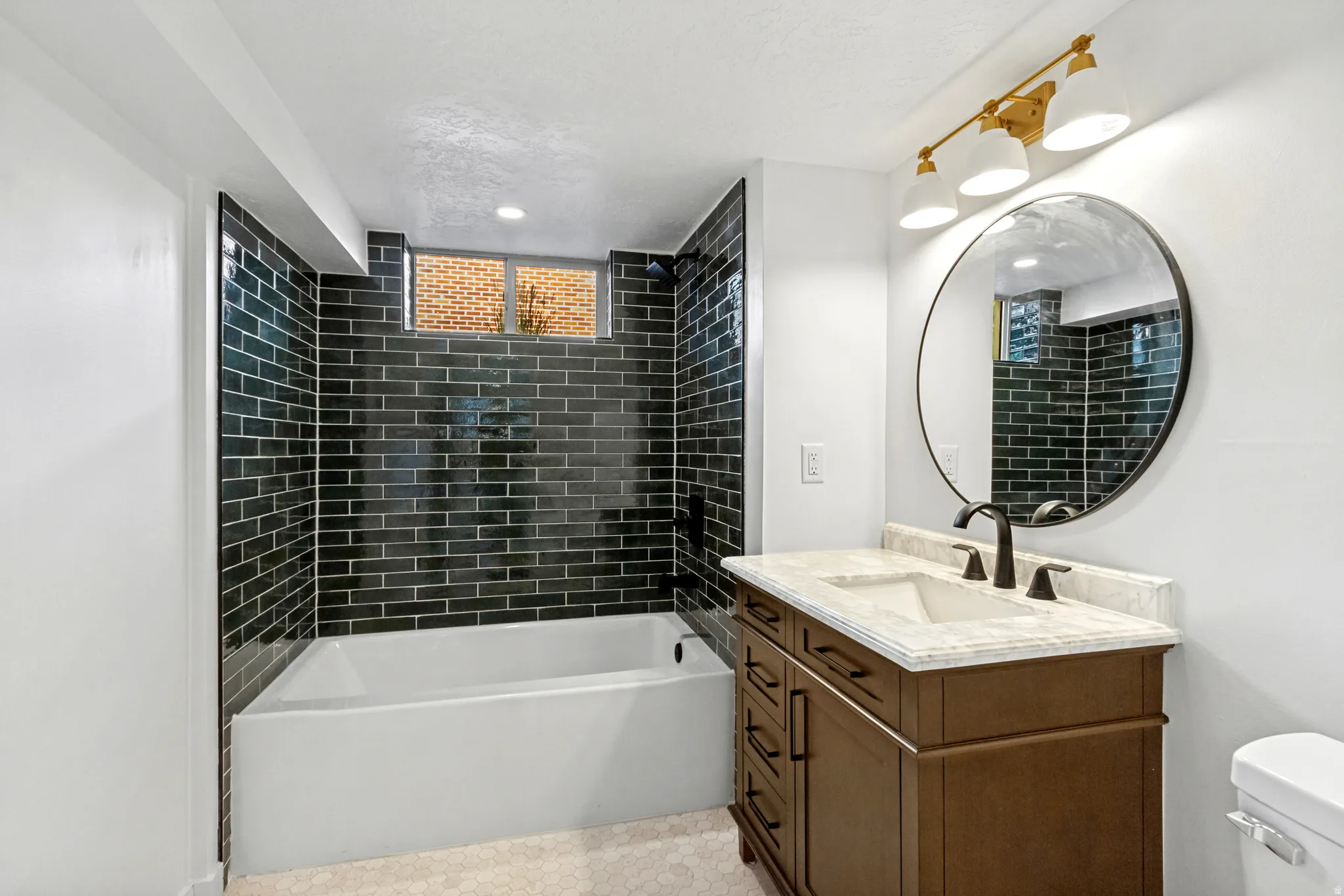 Bathtub with dark subway tile surround