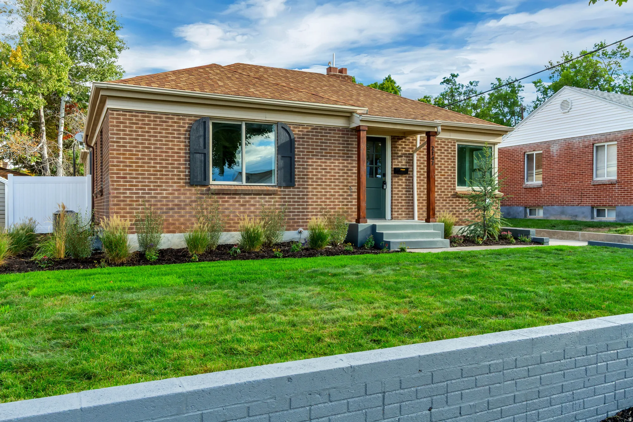 Brick exterior with a gabled roof and dark window shutters