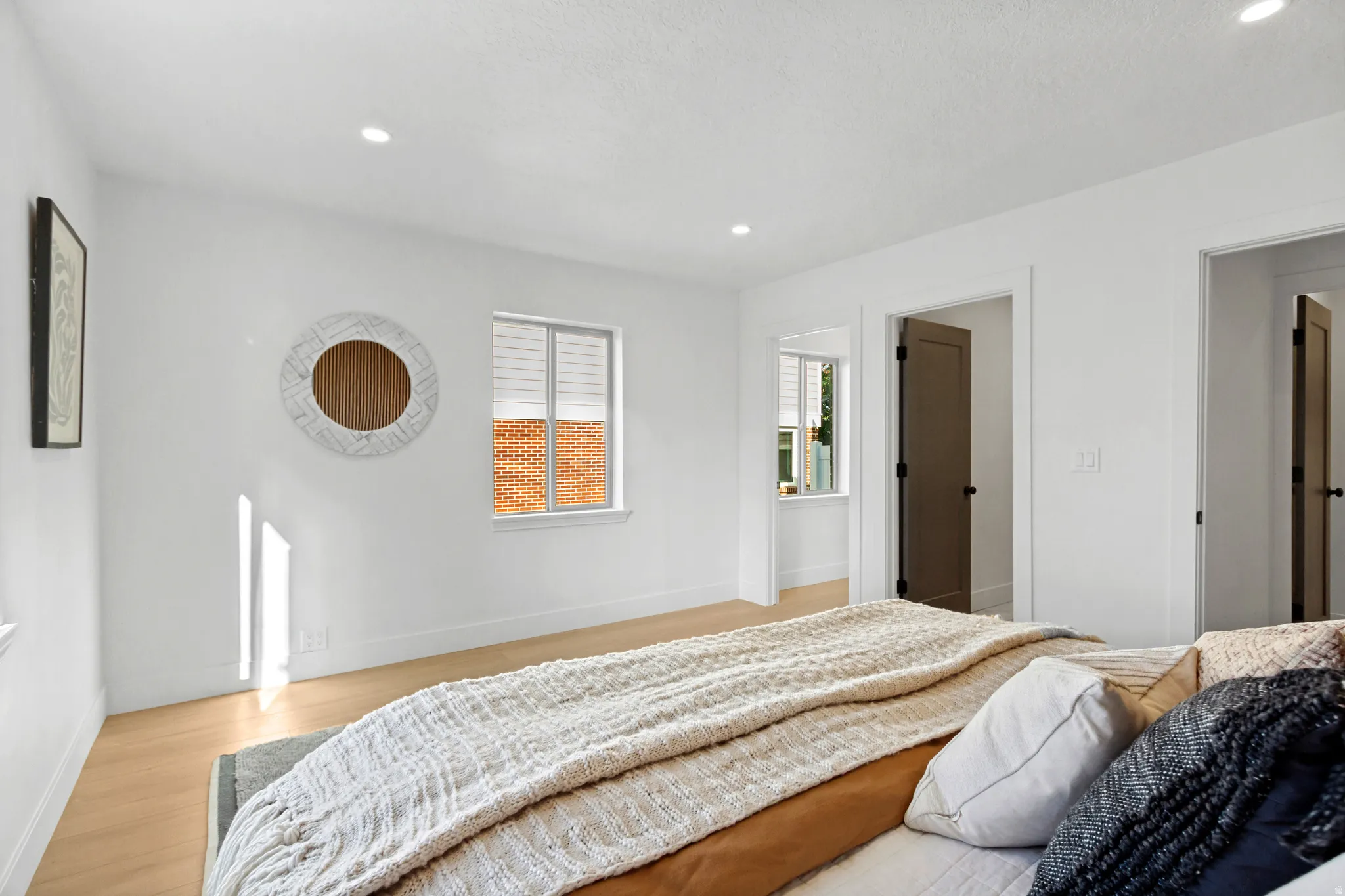 Wood-finish flooring with white walls and trim