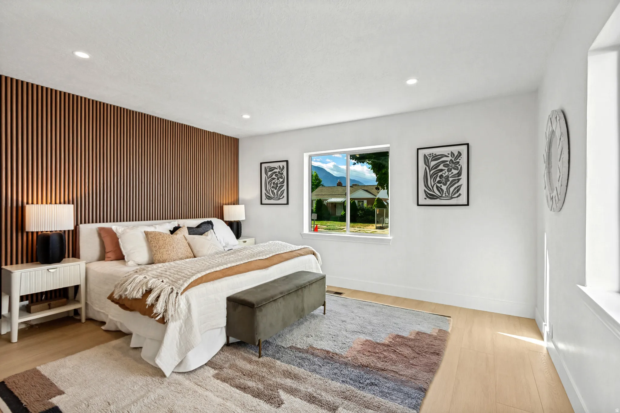 Decorative slat wall paneling, recessed lighting, wood-finish flooring, and white wall finishes