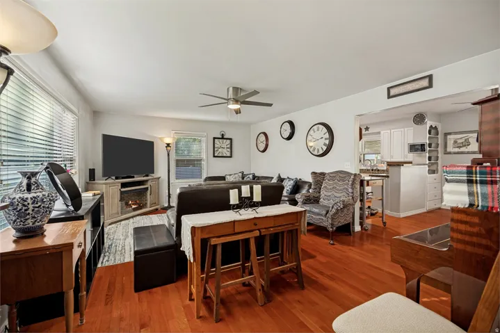 Hardwood flooring throughout, recessed lighting, and a ceiling fan