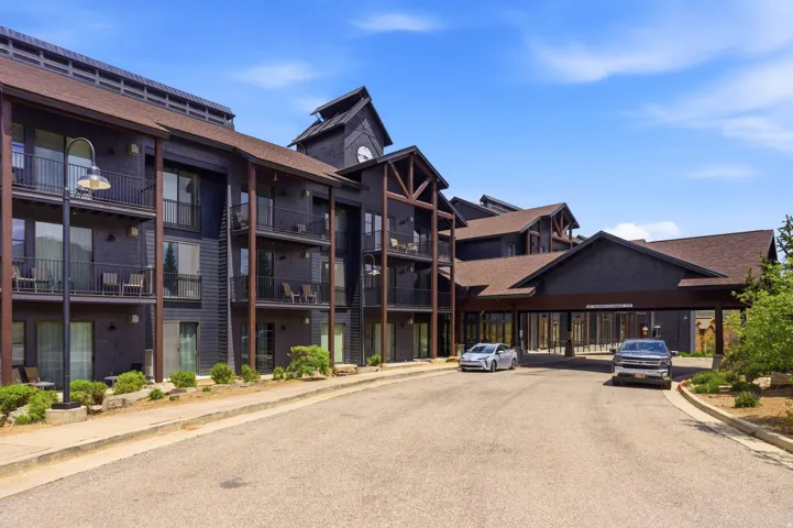Multi-story exterior with dark siding and multiple private balconies