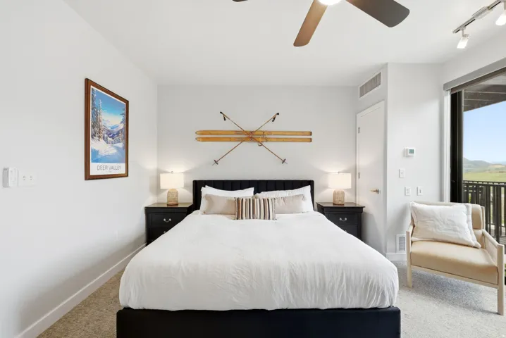 Room featuring a ceiling fan, track lighting, and a sliding glass door