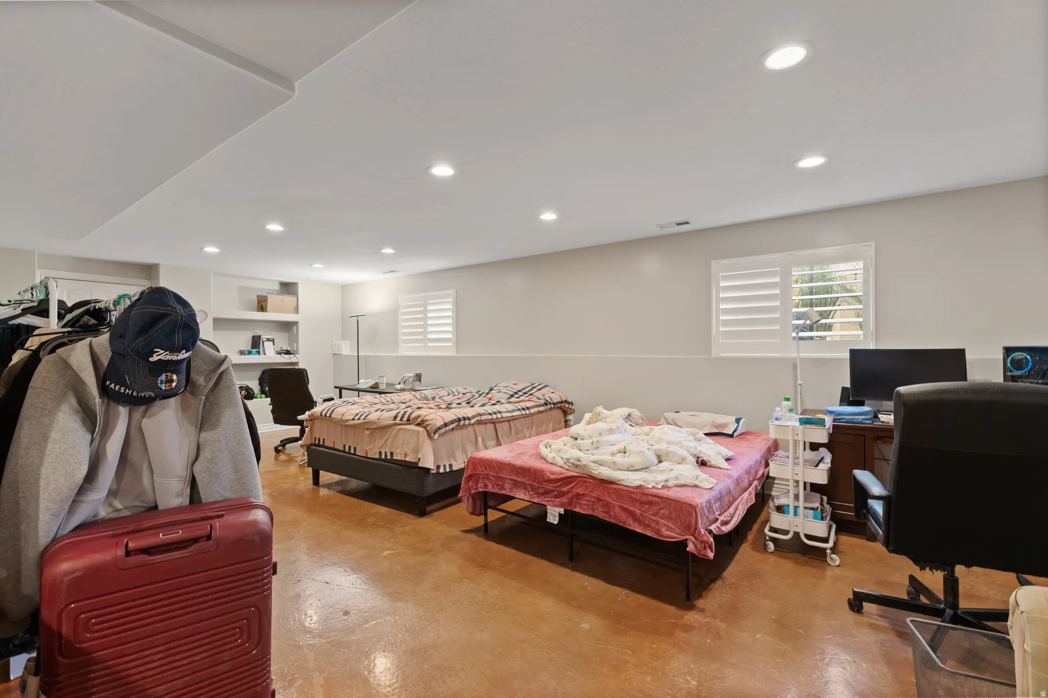 Recessed lighting, painted walls, and window with plantation shutters