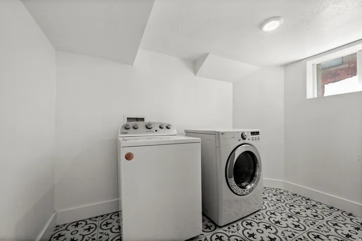 Laundry area with patterned floor tile, recessed lighting, and a utility window