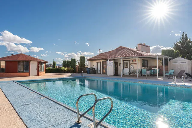 Expansive outdoor swimming pool with integrated entry steps and perimeter decking