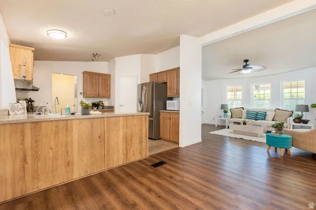 Open concept living area with wood-finish flooring