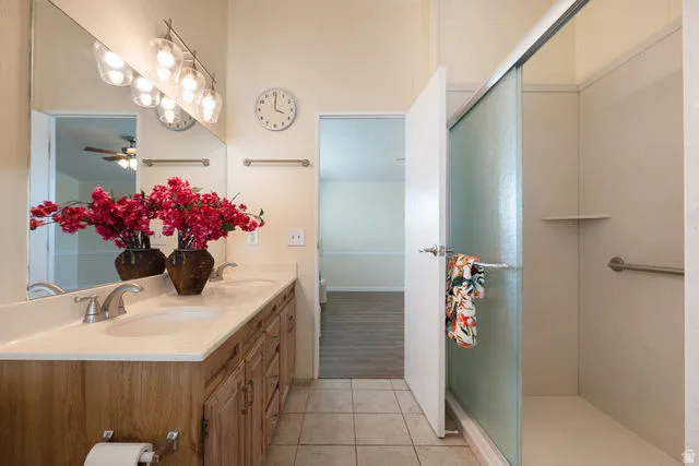Dual sink vanity with light-toned countertops and wood-finish cabinetry