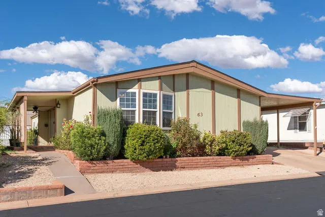 Light green siding exterior with brown trim