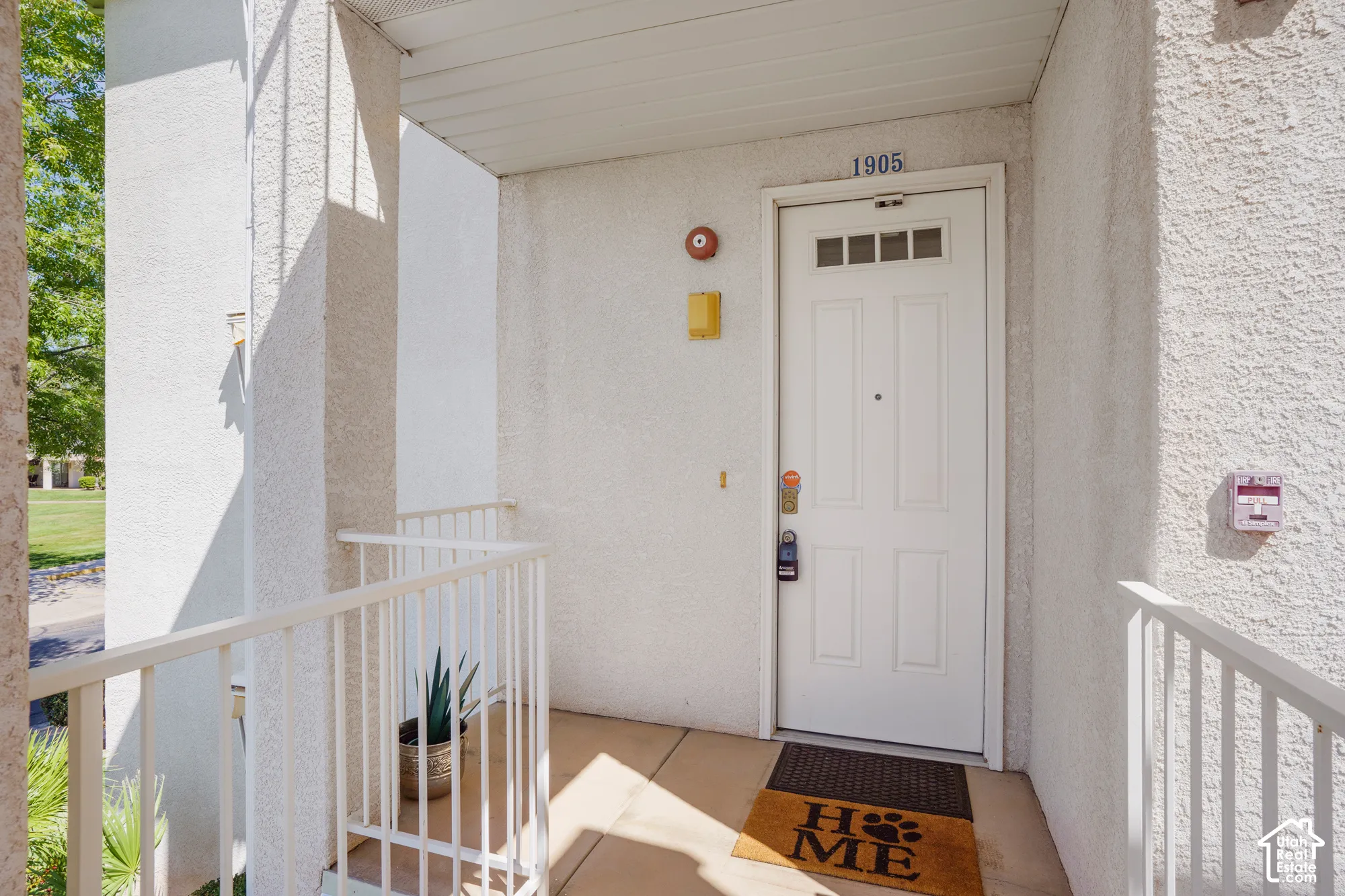 Entry door with multi-pane window and overhead unit number