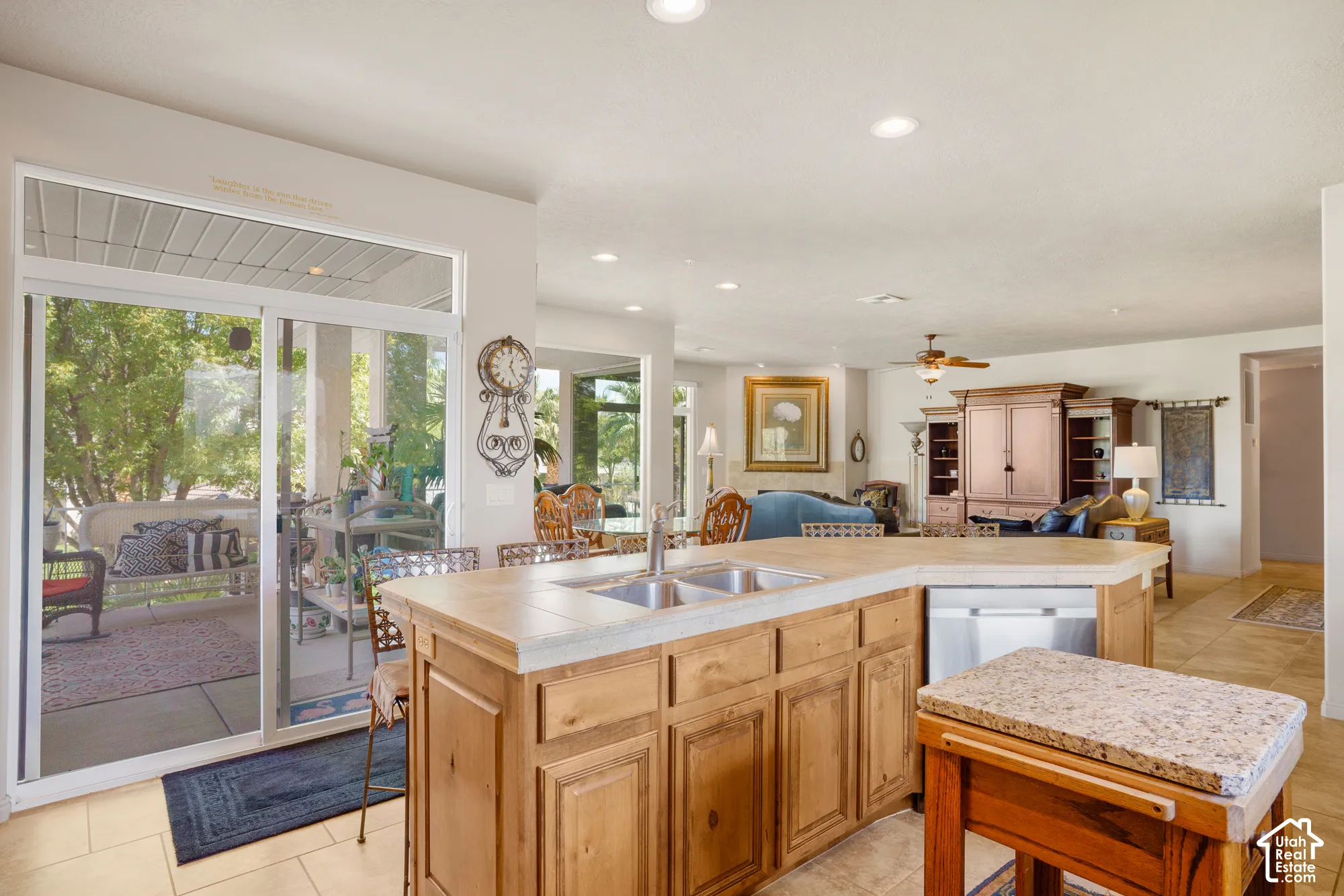 Kitchen island featuring a double-basin sink and integrated dishwasher