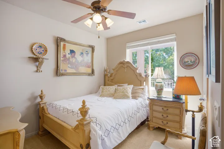 Ceiling fan with integrated lighting, window with horizontal blinds, neutral wall paint, and wall-to-wall carpeting