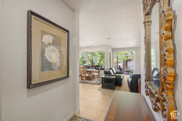 Recessed lighting, tile flooring, glass doors, and expansive windows