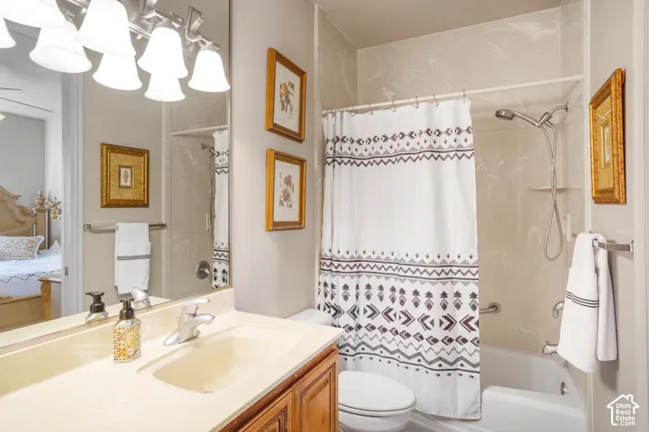 Bathroom featuring a vanity with an integrated sink, polished chrome faucet, and wood-finish cabinetry