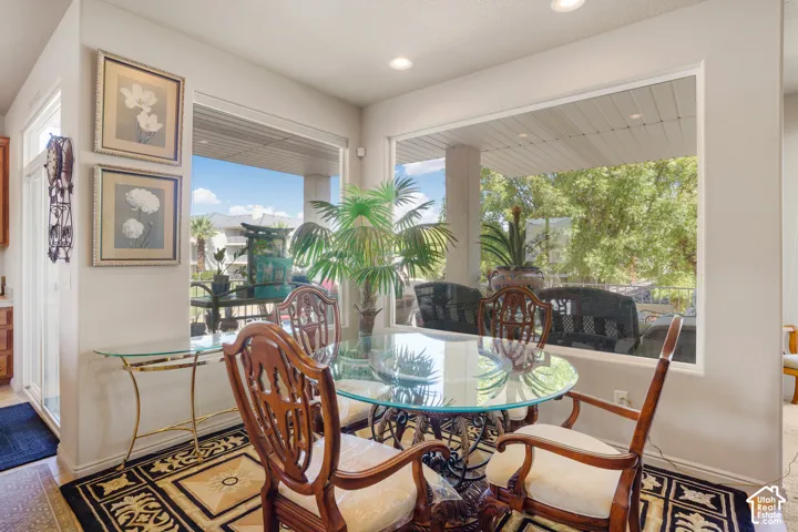 Large window overlooking an outdoor patio with distant greenery
