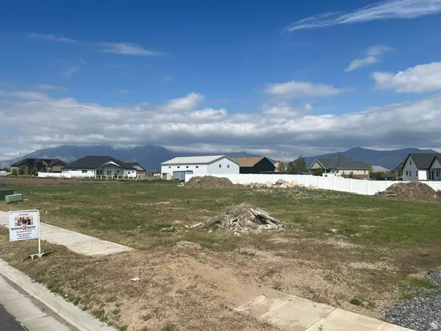 Expansive lot featuring a concrete sidewalk and curb