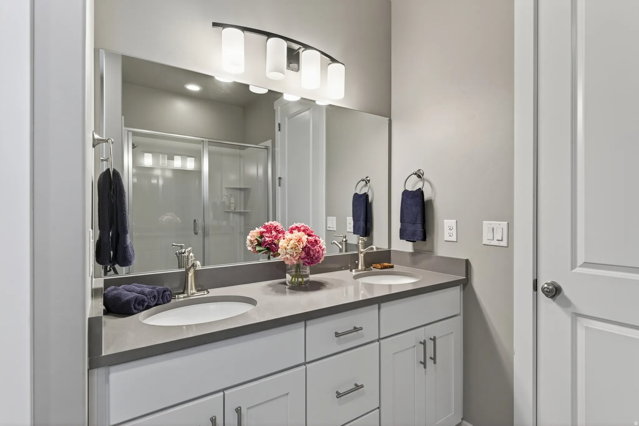 Double vanity with integrated sinks and a stone countertop