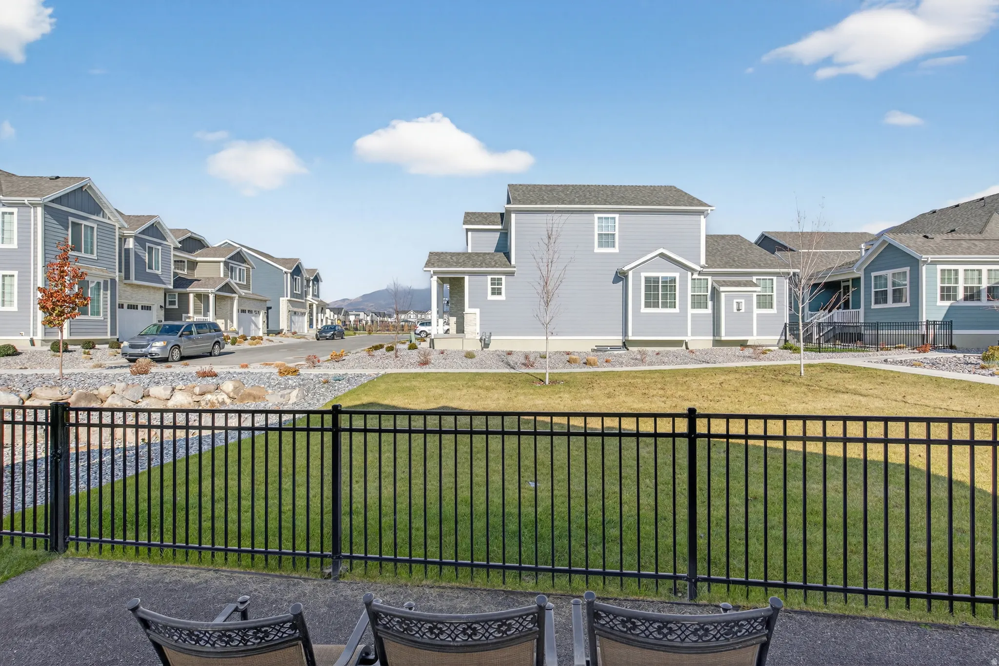 Expansive green space with an iron fence