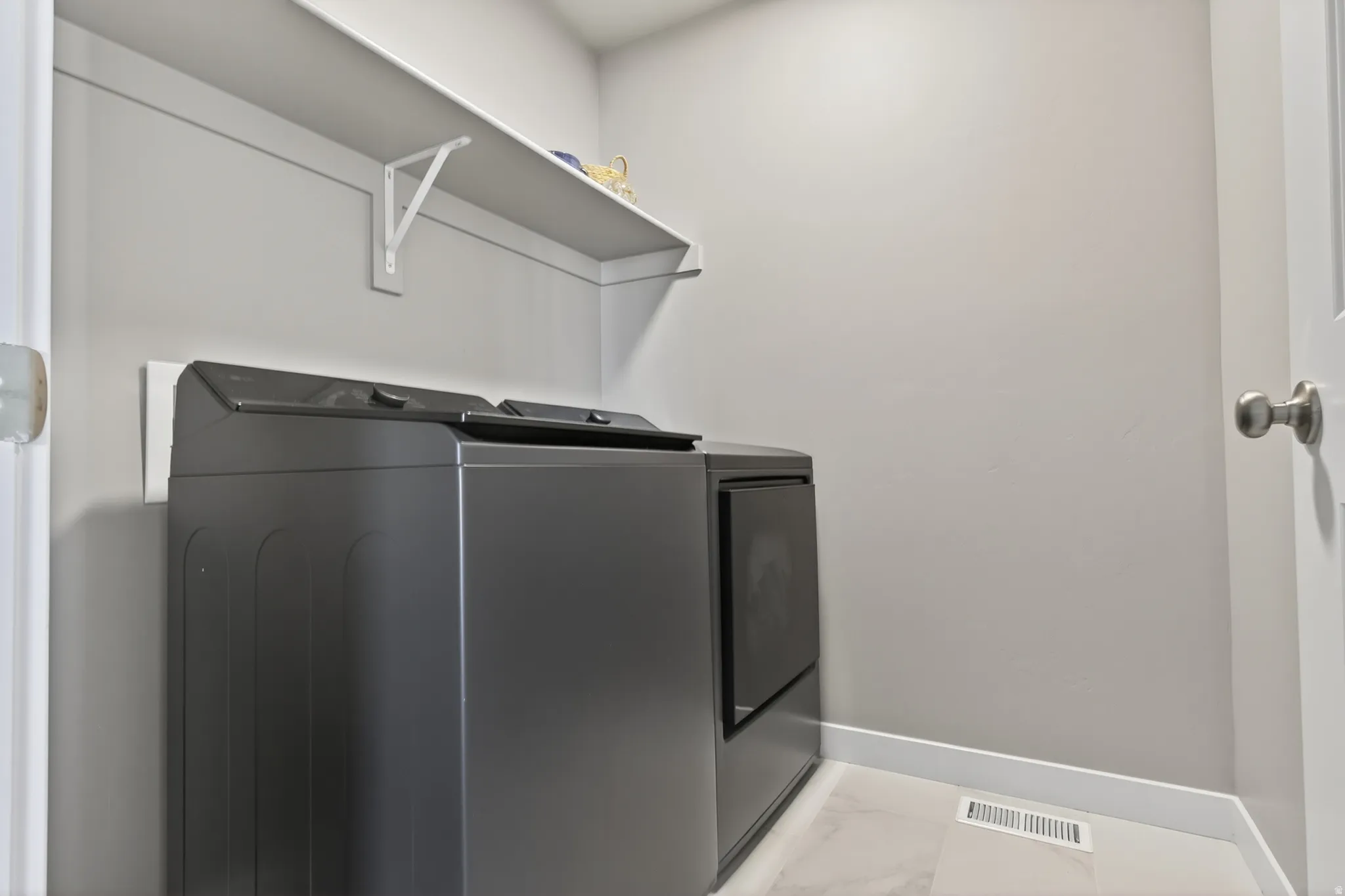 White wall-mounted shelving above appliances