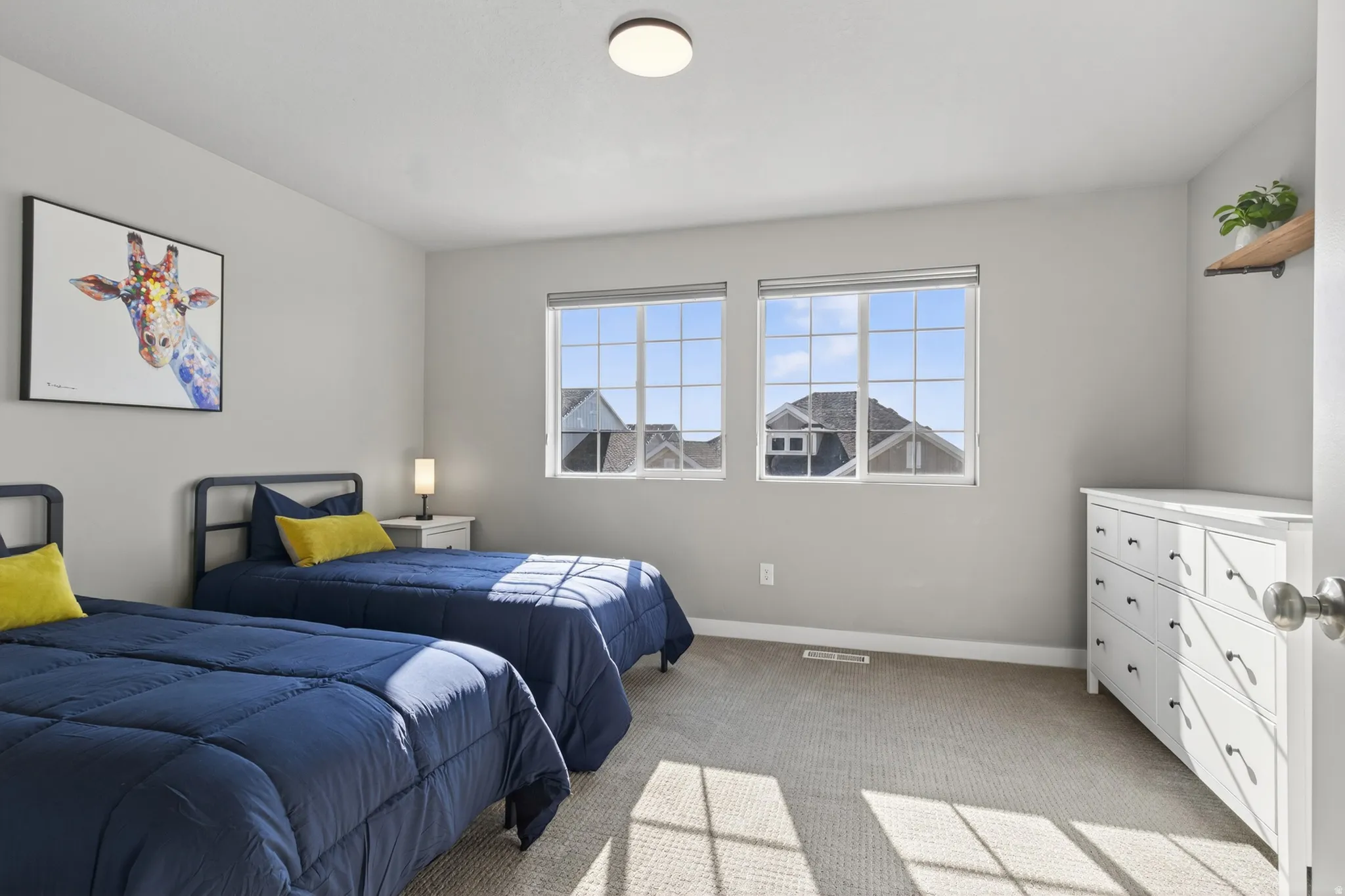 Carpeted room featuring two double-pane windows, a recessed ceiling light, and light gray wall paint