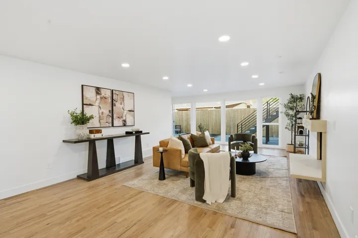 Recessed ceiling lighting, wood-finish flooring, white walls, and a built-in wall shelf