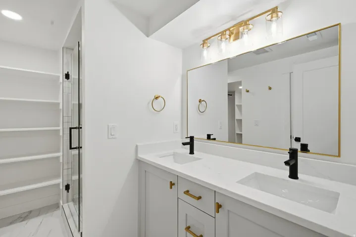 Dual vanity with integrated sinks, quartz countertop, and matte black fixtures