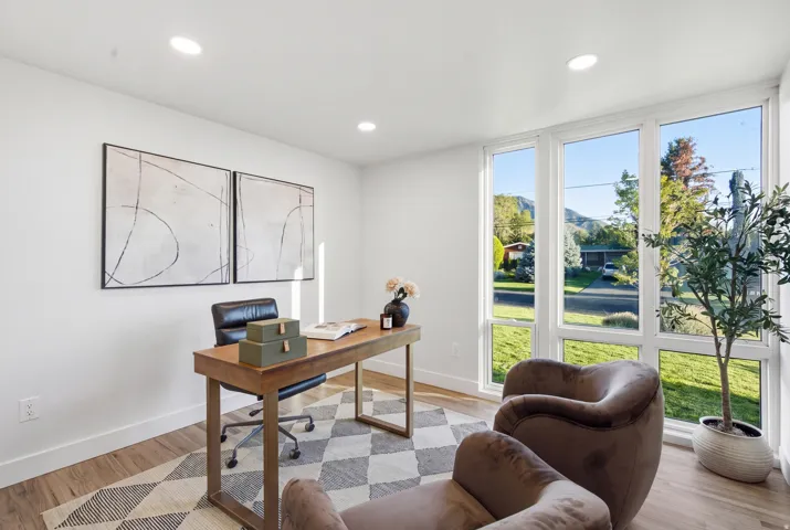 Recessed lighting, wood-finish flooring, white walls, and large windows