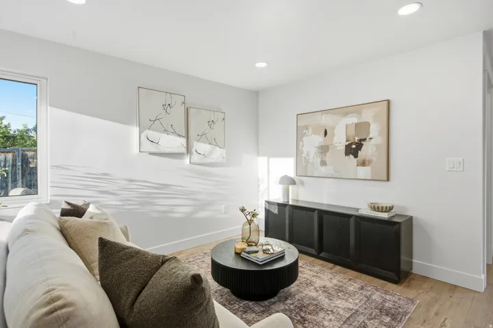 Recessed lighting, wood-finish flooring, and a large window