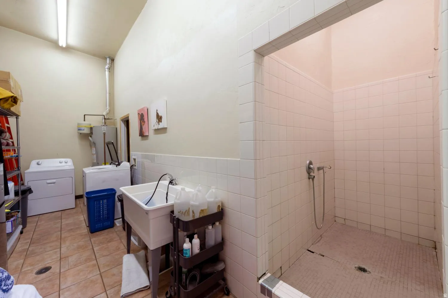 Utility room with tiled flooring and a utility sink