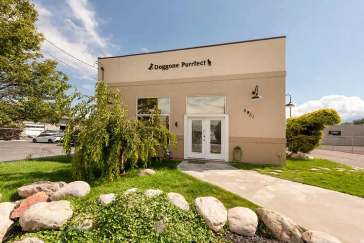 Stucco exterior with a flat roofline and integrated signage