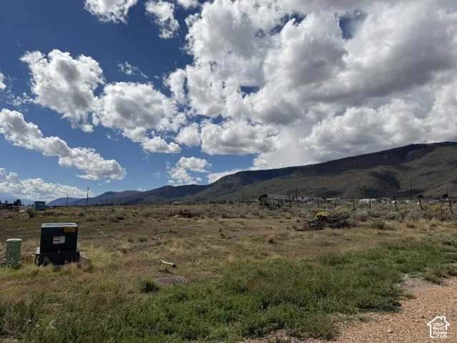 Expansive undeveloped land featuring a mountainous backdrop and clear skies