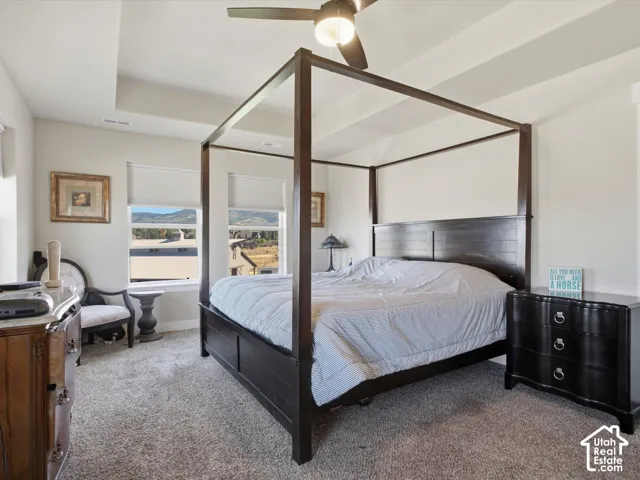 Carpeted room featuring a tray ceiling, recessed lighting, and a ceiling fan