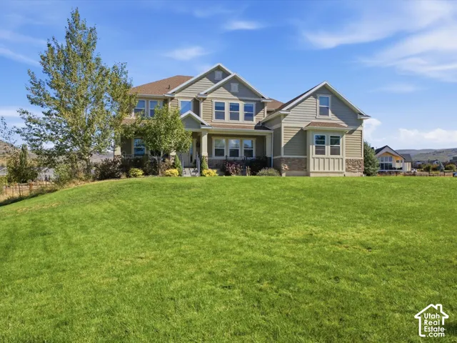 Two-story exterior with light green siding and stone accents