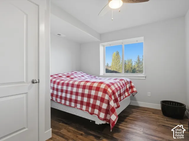 Wood-finish flooring, white walls, and a window with a natural backdrop