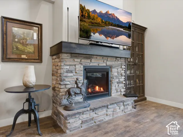 Stacked stone fireplace with a dark wood mantel and a built-in firebox