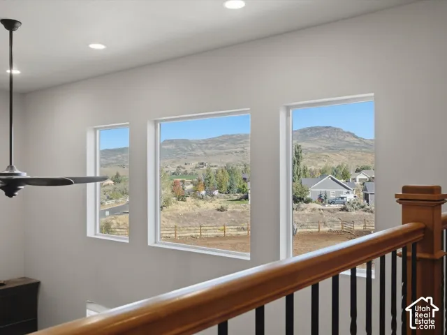 Recessed lighting, ceiling fan, and white walls