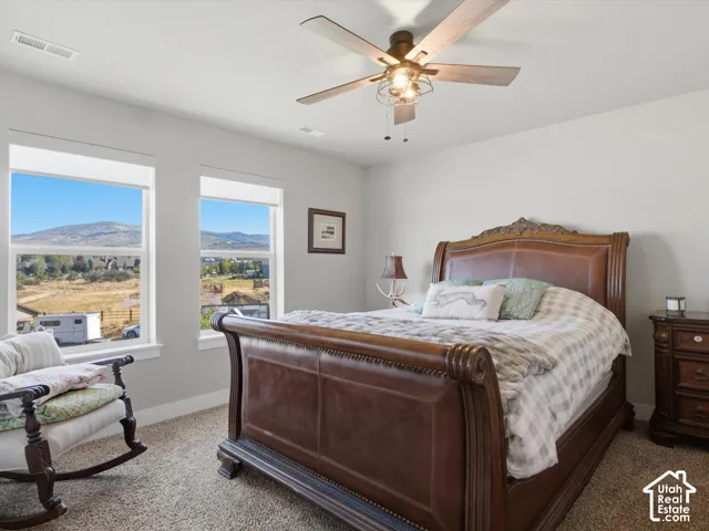 Light gray walls with dual windows framing mountain scenery